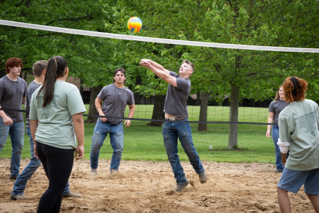 Bumping volleyball over net.