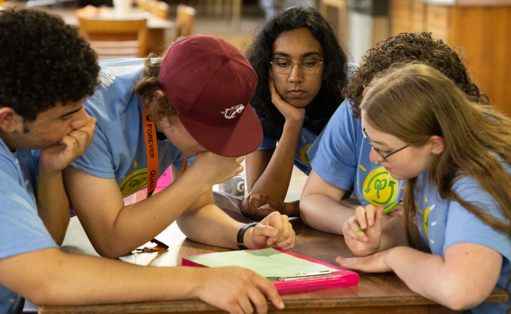 Group of students gathered around to take forestry test.