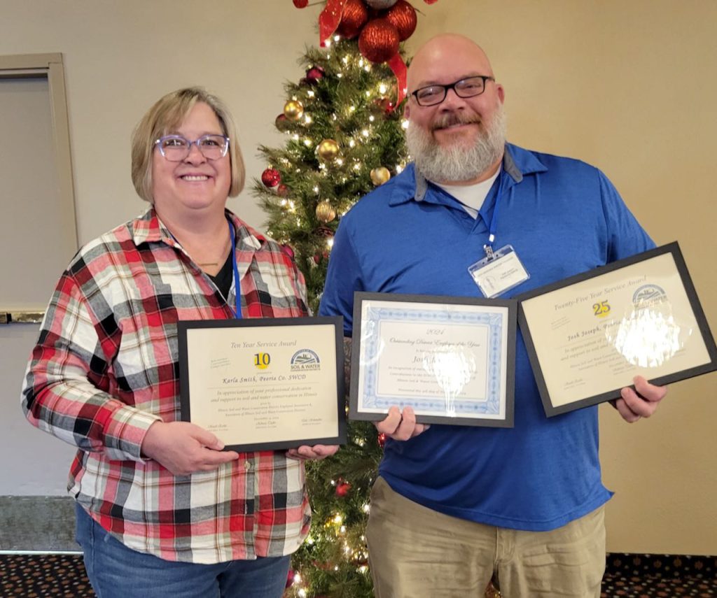 Josh and Karla stand with award certificates